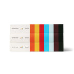 Three copies of Volume III stacked flat, with the colored stripes visible along the spine edge